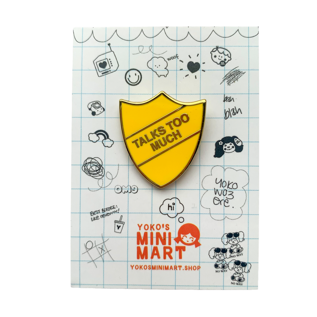 Yellow and gold enamel pin on 80's style backing card